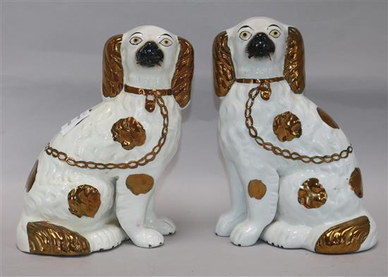 A pair of Staffordshire white and copper lustre dogs height 21cm